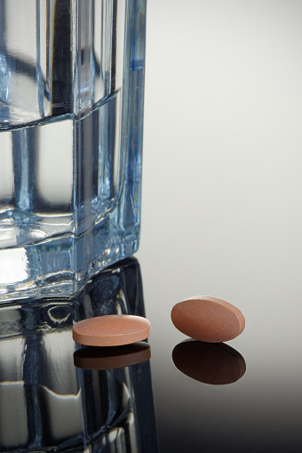 Statin Tablets with Glass of Water